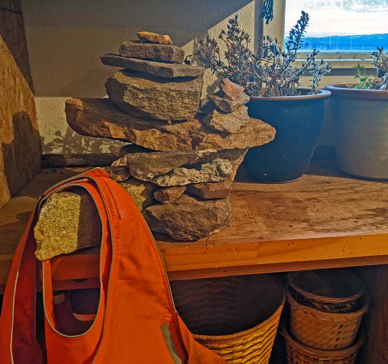 stack of rocks on table, orange vests