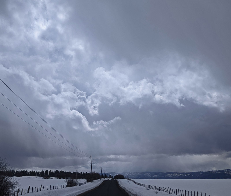 clouds, falling snow, country road