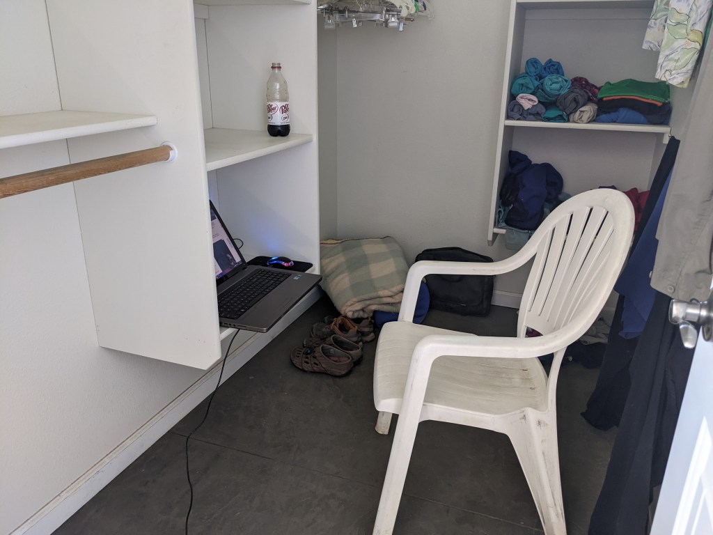 chair and laptop in closet