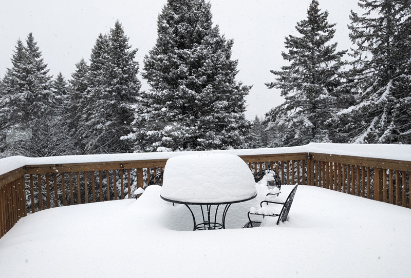 two-plus feet of snow piled on deck table and chairs
